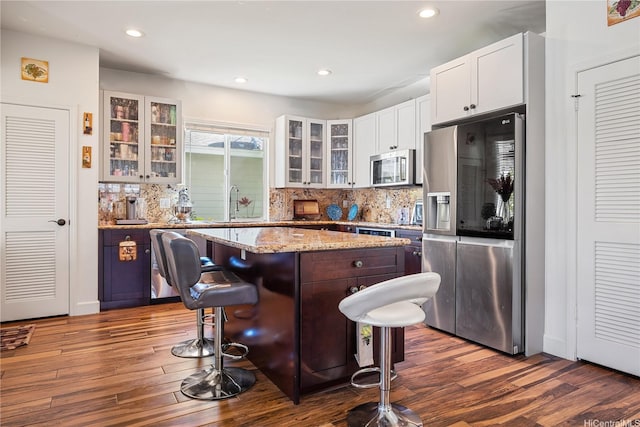 91-1108 Kaihohonu St, Ewa Beach, HI 96706 - kitchen featuring appliances with stainless steel finishes, a center island, dark wood-style floors, decorative backsplash, and recessed lighting