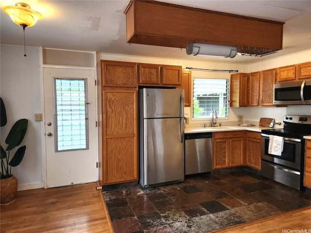 327 Hualani St Unit B, Kailua, HI 96734 - kitchen featuring appliances with stainless steel finishes, brown cabinets, plenty of natural light, and light countertops