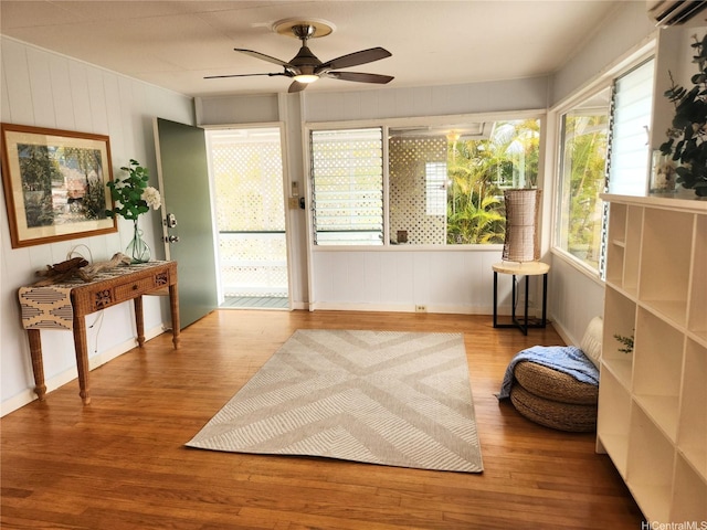 327 Hualani St Unit B, Kailua, HI 96734 - sitting room with wood finished floors, a ceiling fan, and a wall unit AC