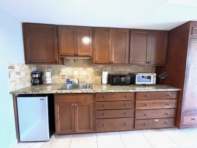 2045 Kalakaua Ave Unit 402, Honolulu, HI 96815 - kitchen with refrigerator, black microwave, tasteful backsplash, and light stone countertops