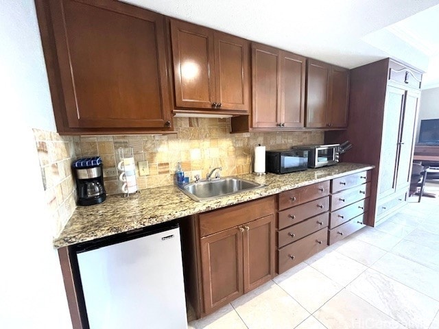 2045 Kalakaua Ave Unit 402, Honolulu, HI 96815 - kitchen with refrigerator, decorative backsplash, black microwave, light stone countertops, and light tile patterned floors