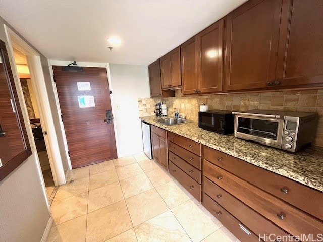 2045 Kalakaua Ave Unit 402, Honolulu, HI 96815 - kitchen with black microwave, backsplash, dishwasher, light stone countertops, and light tile patterned floors