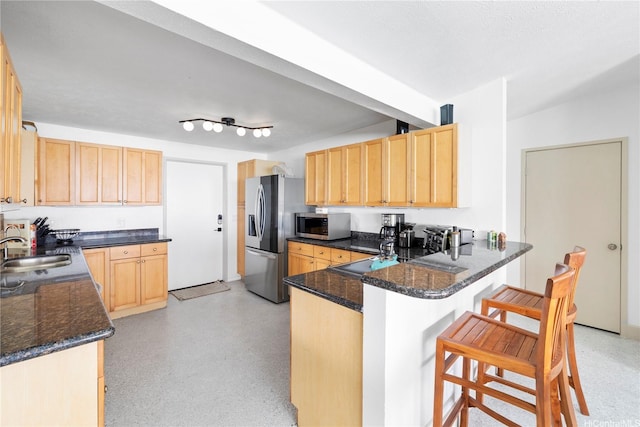 68-665 Hoomana Pl, Waialua, HI 96791 - kitchen with a peninsula, appliances with stainless steel finishes, light brown cabinets, and a breakfast bar