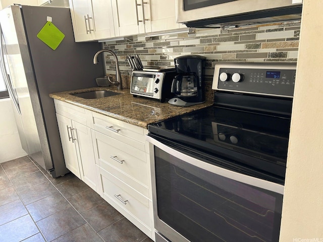 201 Ohua Ave Unit 2406, Honolulu, HI 96815 - kitchen with stainless steel appliances, tasteful backsplash, stone counters, and white cabinets