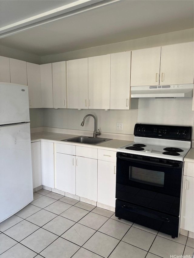 1616 Liholiho St Unit 803, Honolulu, HI 96822 - kitchen with freestanding refrigerator, range with electric cooktop, under cabinet range hood, light countertops, and light tile patterned floors