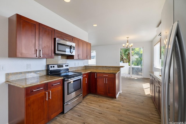 92-7049 Elele St Unit 54, Kapolei, HI 96707 - kitchen with stainless steel appliances, a peninsula, light wood-style flooring, a chandelier, and recessed lighting