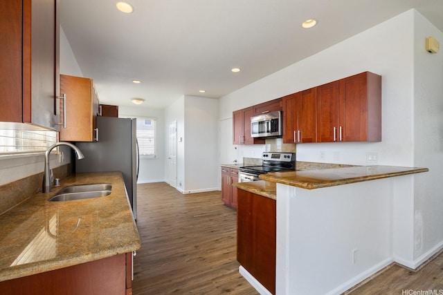 92-7049 Elele St Unit 54, Kapolei, HI 96707 - kitchen with stainless steel appliances, dark wood finished floors, a peninsula, light stone counters, and recessed lighting