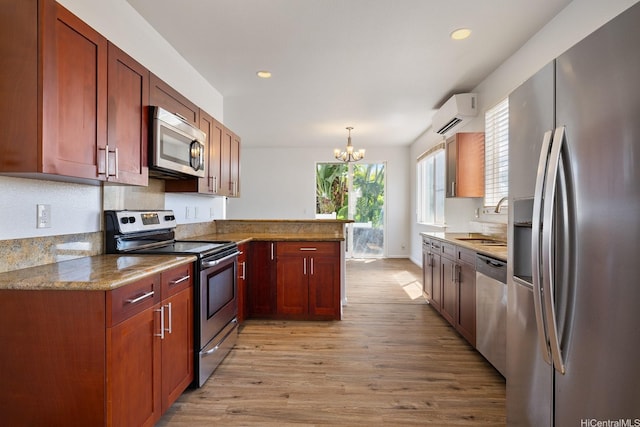92-7049 Elele St Unit 54, Kapolei, HI 96707 - kitchen featuring stainless steel appliances, light wood-style floors, a peninsula, a chandelier, and recessed lighting