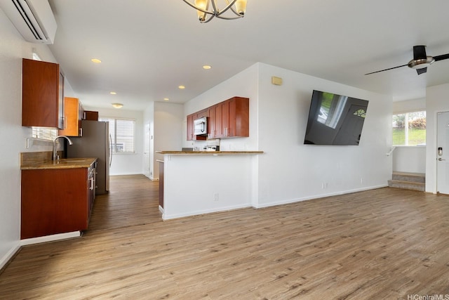 92-7049 Elele St Unit 54, Kapolei, HI 96707 - kitchen with a wall mounted air conditioner, plenty of natural light, light wood finished floors, stainless steel microwave, and recessed lighting