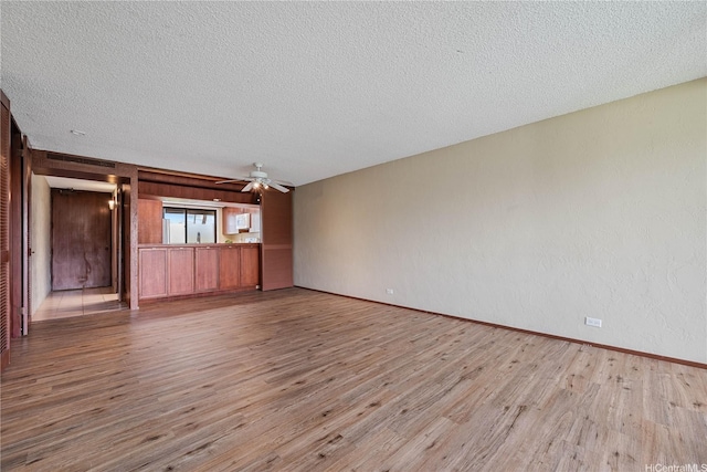 500 Lunalilo Home Rd Unit 24K, Honolulu, HI 96825 - unfurnished living room with wood finished floors, a textured ceiling, and a ceiling fan