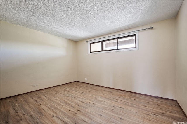 500 Lunalilo Home Rd Unit 24K, Honolulu, HI 96825 - empty room featuring wood finished floors and a textured ceiling