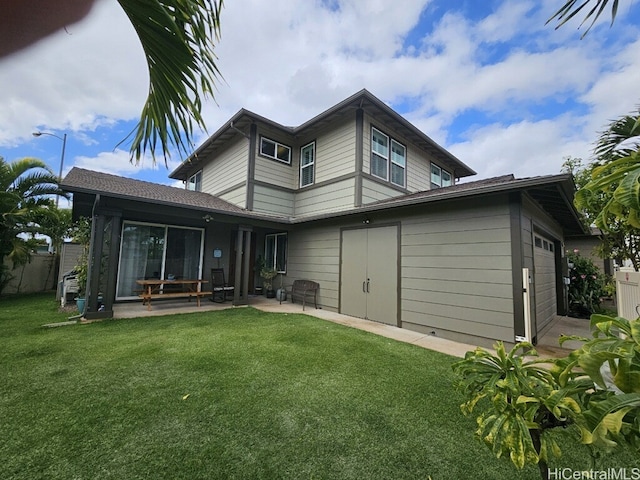 91-504 Kakaha St, Ewa Beach, HI 96706 - rear view of house with a lawn, a garage, and a patio