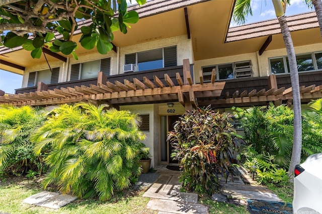 444 Lunalilo Home Rd Unit 602, Honolulu, HI 96825 - rear view of property with stucco siding, cooling unit, and a pergola