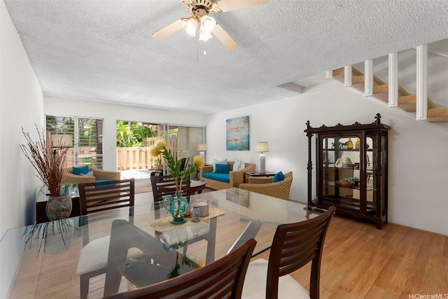 444 Lunalilo Home Rd Unit 602, Honolulu, HI 96825 - dining space with a textured ceiling, wood finished floors, a ceiling fan, and stairway