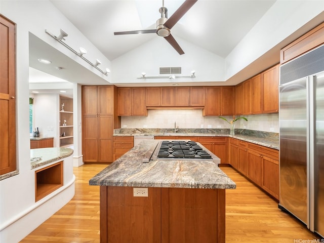 3124 Noela Dr, Honolulu, HI 96815 - kitchen with stainless steel appliances, light wood-style floors, a center island, a ceiling fan, and brown cabinets