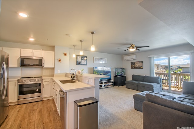 91-3525 Kauluakoko St Unit 2103, Ewa Beach, HI 96706 - kitchen with appliances with stainless steel finishes, open floor plan, a peninsula, a wall mounted air conditioner, and ceiling fan