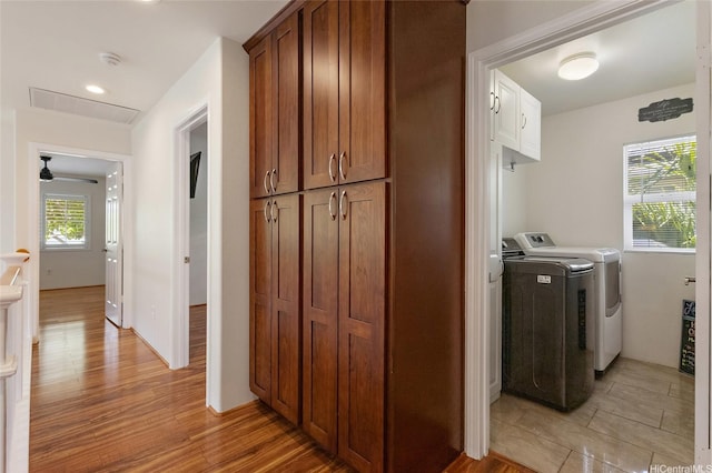 91-1023 Kaiee St, Ewa Beach, HI 96706 - washroom with washer and dryer, light wood-style floors, and cabinet space