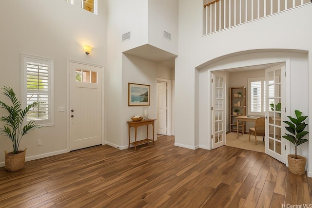 91-1023 Kaiee St, Ewa Beach, HI 96706 - entryway with wood finished floors, arched walkways, a towering ceiling, and french doors