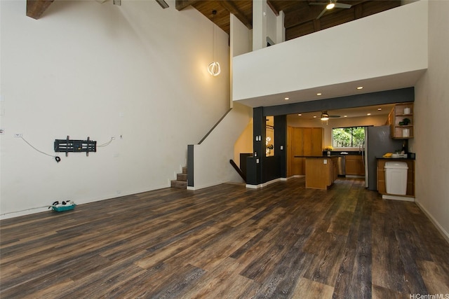46-359 Haiku Rd Unit C10, Kaneohe, HI 96744 - unfurnished living room with dark wood-style floors, ceiling fan, stairs, high vaulted ceiling, and beam ceiling
