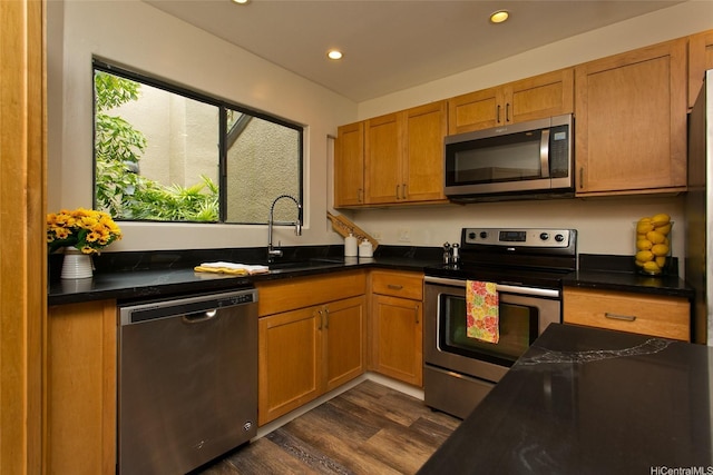 46-359 Haiku Rd Unit C10, Kaneohe, HI 96744 - kitchen featuring appliances with stainless steel finishes, dark wood-type flooring, dark countertops, recessed lighting, and brown cabinets