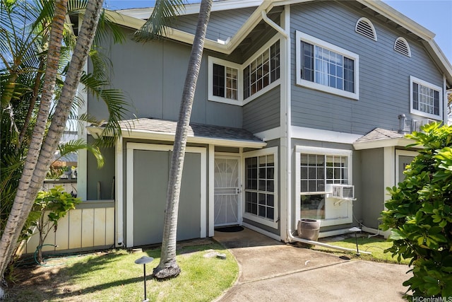 239 Mananai Pl Unit 54H, Honolulu, HI 96818 - view of front of home with a shingled roof and cooling unit