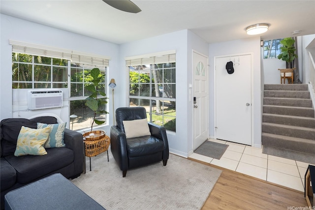 239 Mananai Pl Unit 54H, Honolulu, HI 96818 - foyer entrance with cooling unit, stairs, and wood finished floors