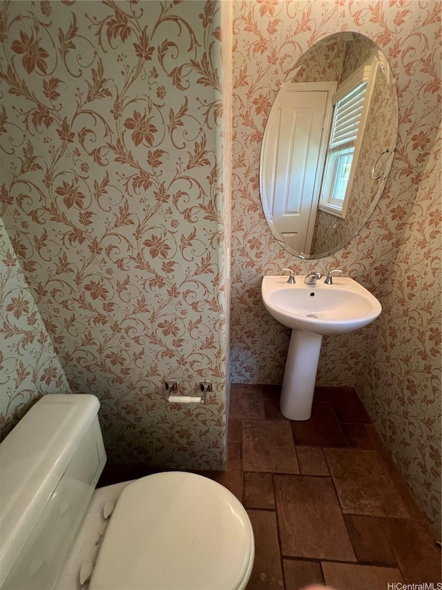91-1035 Kaiko St, Ewa Beach, HI 96706 - half bathroom featuring wallpapered walls and stone finish flooring