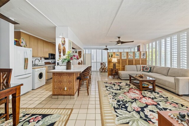 2801 Coconut Ave Unit 2D, Honolulu, HI 96815 - living area with washer / clothes dryer, ceiling fan, floor to ceiling windows, and light tile patterned flooring
