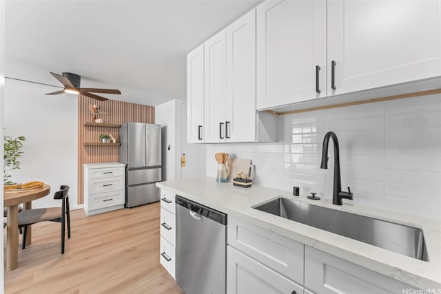 5055 Likini St Unit D226, Honolulu, HI 96818 - kitchen with appliances with stainless steel finishes, decorative backsplash, a ceiling fan, white cabinets, and light stone countertops