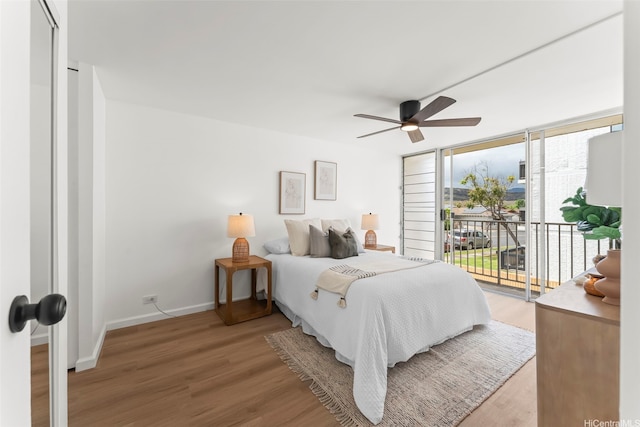 5055 Likini St Unit D226, Honolulu, HI 96818 - bedroom featuring access to outside, light wood-type flooring, and ceiling fan