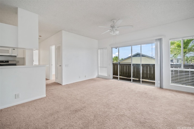 91-234 Hanapouli Cir Unit 28J, Ewa Beach, HI 96706 - unfurnished living room with light carpet, ceiling fan, and a textured ceiling