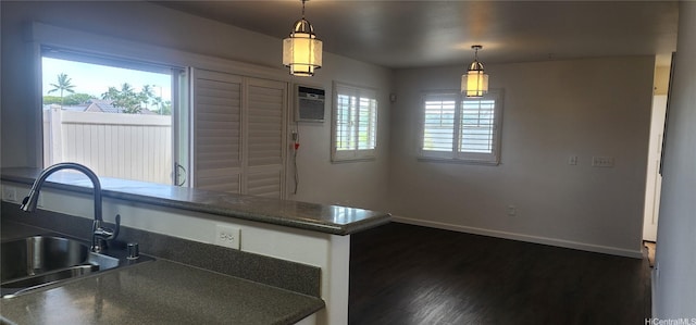 91-1271 Kamaaha Ave Unit 406, Kapolei, HI 96707 - kitchen featuring dark countertops, dark wood-style floors, and hanging light fixtures