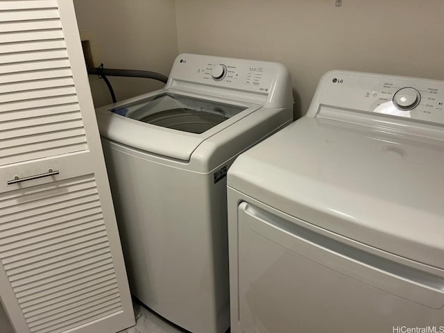91-1271 Kamaaha Ave Unit 406, Kapolei, HI 96707 - laundry area with washing machine and clothes dryer and light marble finish flooring
