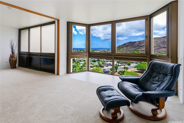 521 Hahaione St Unit 2/12H, Honolulu, HI 96825 - sitting room with carpet floors, a wall of windows, and a water view
