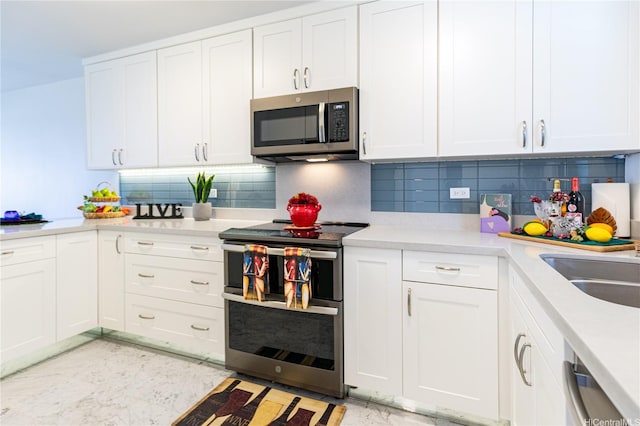 521 Hahaione St Unit 2/12H, Honolulu, HI 96825 - kitchen with stainless steel appliances, white cabinets, light countertops, and decorative backsplash
