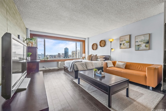 747 Amana St Unit 2206, Honolulu, HI 96814 - bedroom with dark wood-type flooring, a skyline view, and a textured ceiling