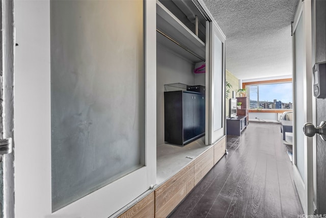 747 Amana St Unit 2206, Honolulu, HI 96814 - corridor with dark wood-type flooring and a textured ceiling