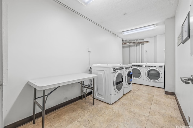 747 Amana St Unit 2206, Honolulu, HI 96814 - communal laundry room featuring washing machine and clothes dryer and baseboards