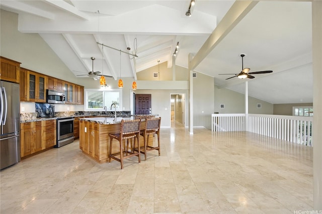866 Kaahue St, Honolulu, HI 96825 - kitchen featuring appliances with stainless steel finishes, a ceiling fan, brown cabinets, light stone countertops, and beamed ceiling