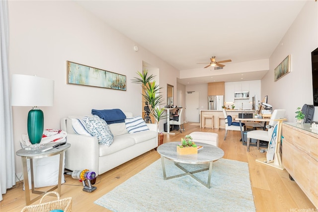 1001 Queen St Unit 3907, Honolulu, HI 96814 - living room featuring a ceiling fan and light wood-type flooring