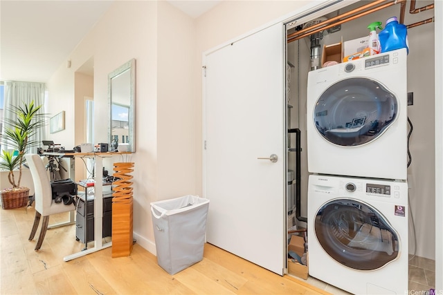 1001 Queen St Unit 3907, Honolulu, HI 96814 - washroom with estacked washer and dryer and light wood-style flooring