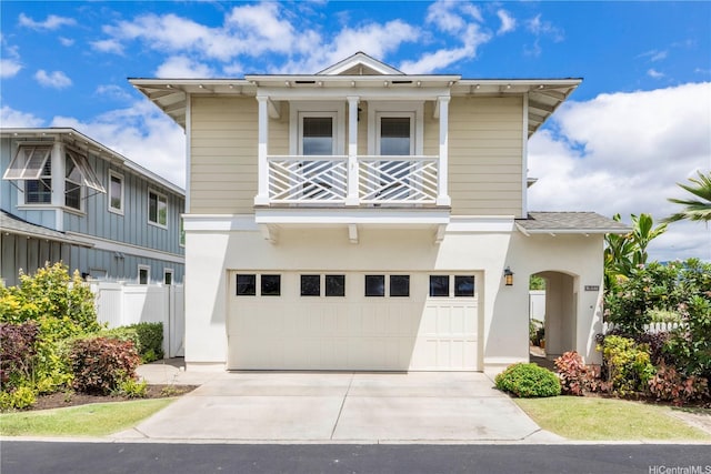 91-1144 Kaikohola St Unit D71, Ewa Beach, HI 96706 - view of front of home with a balcony, a garage, driveway, and stucco siding