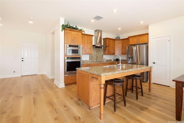 91-1144 Kaikohola St Unit D71, Ewa Beach, HI 96706 - kitchen featuring wall chimney exhaust hood, stainless steel fridge with ice dispenser, light wood-type flooring, a breakfast bar area, and recessed lighting