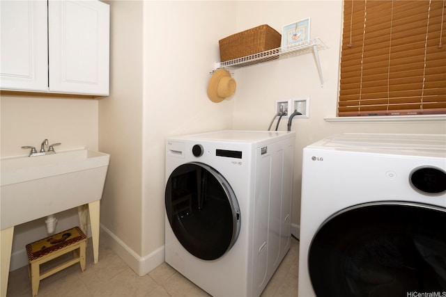 91-1144 Kaikohola St Unit D71, Ewa Beach, HI 96706 - laundry area featuring washing machine and dryer, cabinet space, and light tile patterned floors