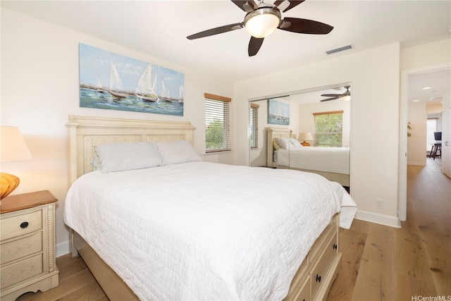 91-1144 Kaikohola St Unit D71, Ewa Beach, HI 96706 - bedroom featuring light wood finished floors, multiple windows, ceiling fan, and a closet