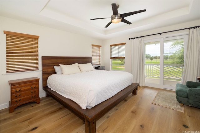 91-1144 Kaikohola St Unit D71, Ewa Beach, HI 96706 - bedroom with a raised ceiling, access to exterior, light wood finished floors, and a ceiling fan