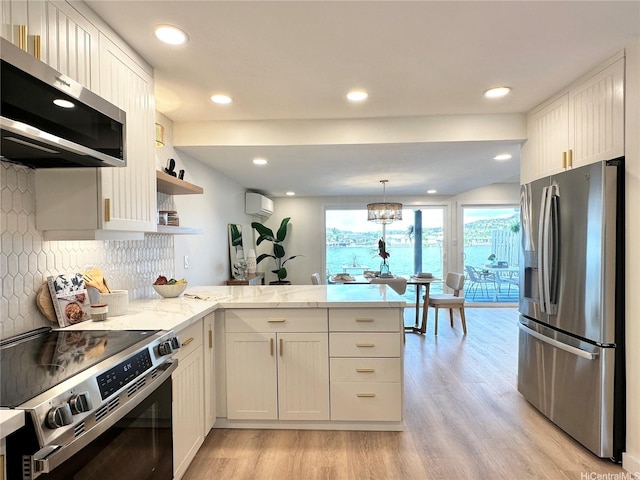 539 Keolu Dr Unit C, Kailua, HI 96734 - kitchen featuring stainless steel appliances, a peninsula, light wood-style flooring, a wall unit AC, and light stone counters