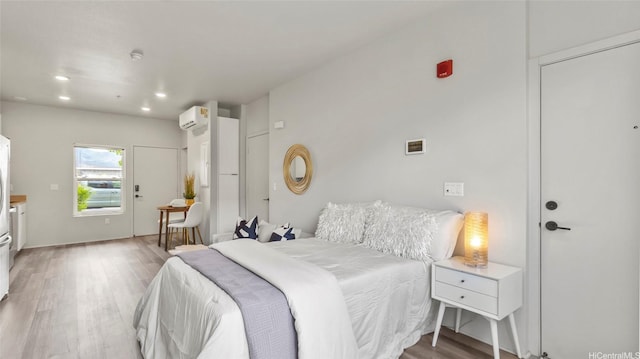91-3617 Kamolehonua St Unit 208, Ewa Beach, HI 96706 - bedroom featuring a wall mounted AC, wood finished floors, and recessed lighting