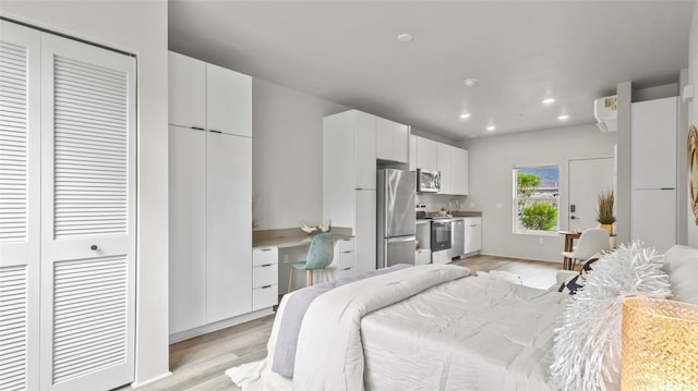 91-3617 Kamolehonua St Unit 208, Ewa Beach, HI 96706 - bedroom with freestanding refrigerator, light wood-type flooring, built in study area, and recessed lighting