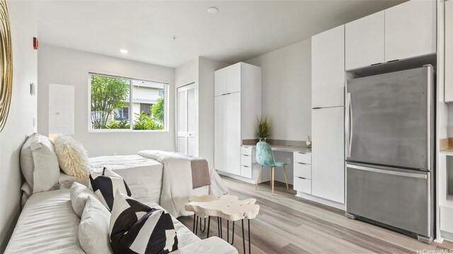 91-3617 Kamolehonua St Unit 208, Ewa Beach, HI 96706 - bedroom with freestanding refrigerator, light wood-type flooring, recessed lighting, electric panel, and a closet